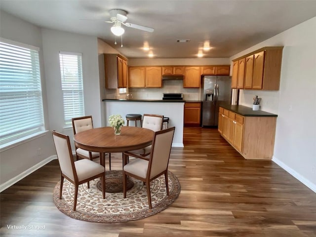 dining room featuring dark hardwood / wood-style flooring and ceiling fan