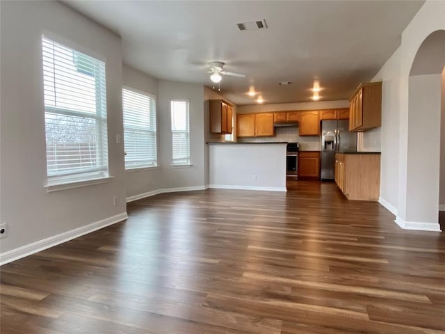 kitchen featuring appliances with stainless steel finishes, dark wood-type flooring, and ceiling fan