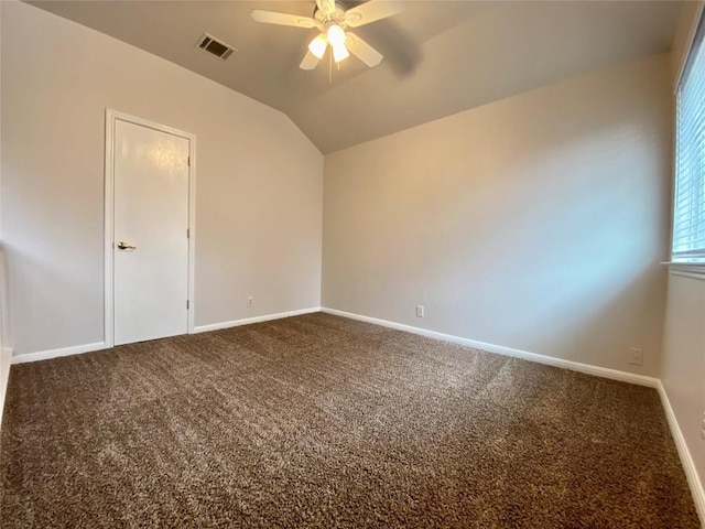 empty room featuring ceiling fan, carpet flooring, and vaulted ceiling