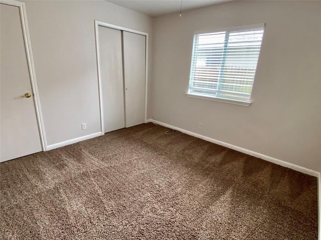 unfurnished bedroom featuring a closet and carpet