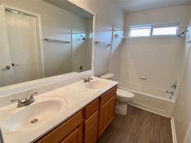 full bathroom featuring vanity, hardwood / wood-style flooring, tub / shower combination, and toilet