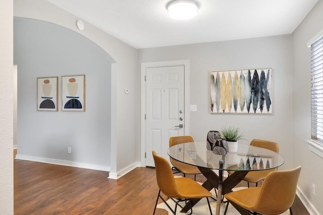 dining space with dark hardwood / wood-style floors