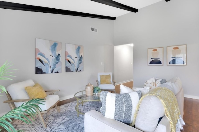 living room with vaulted ceiling with beams and hardwood / wood-style floors