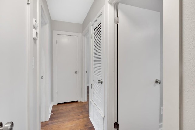 hall with hardwood / wood-style flooring