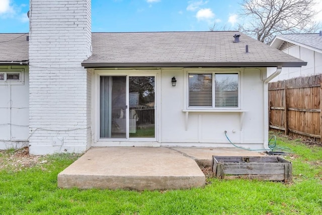 back of property featuring a patio area and a lawn