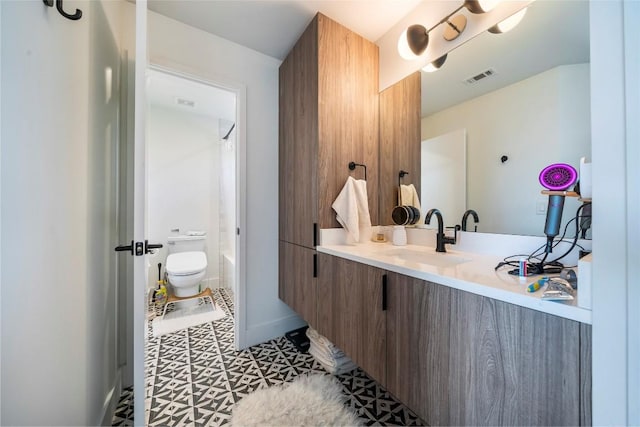 bathroom featuring vanity and toilet