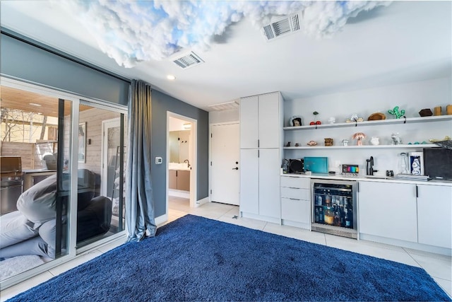 bar with white cabinetry, light tile patterned floors, and beverage cooler