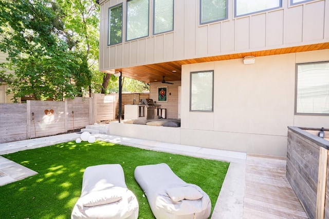 view of yard featuring ceiling fan and a patio area