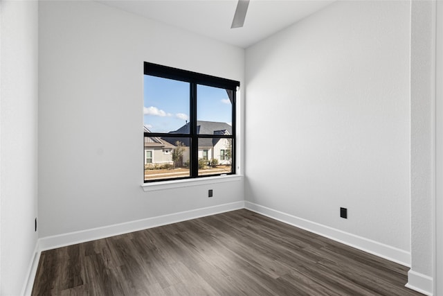 313 Starfire Dr, Dripping Springs, TX 78620 - empty room with a ceiling fan, dark wood-style floors, and baseboards