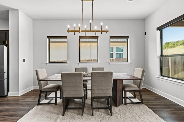 313 Starfire Dr, Dripping Springs, TX 78620 - dining room with wood finished floors, baseboards, and a chandelier