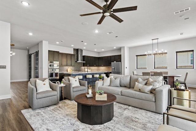 313 Starfire Dr, Dripping Springs, TX 78620 - living area with baseboards, a ceiling fan, a chandelier, wood finished floors, and recessed lighting