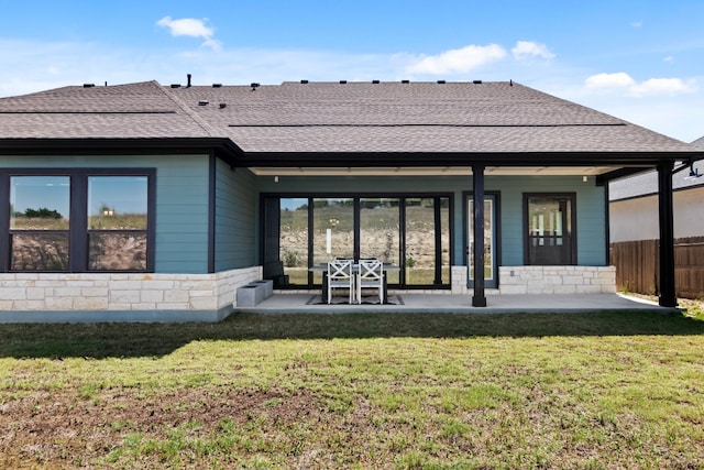 313 Starfire Dr, Dripping Springs, TX 78620 - back of house with roof with shingles, stone siding, and a patio area
