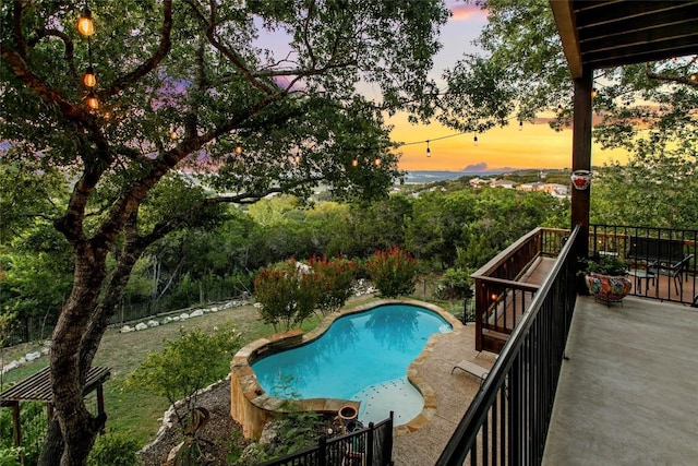 view of pool at dusk