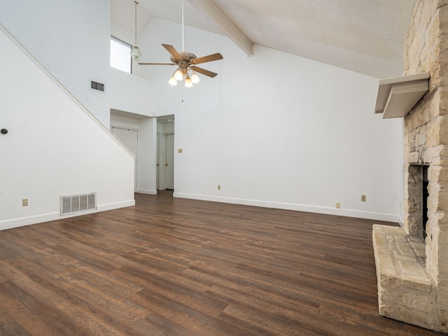 unfurnished living room featuring dark wood-type flooring, ceiling fan, high vaulted ceiling, a textured ceiling, and a stone fireplace