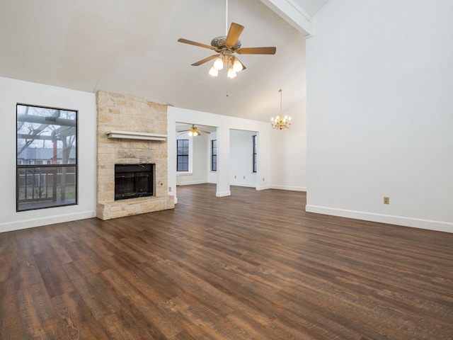 unfurnished living room featuring high vaulted ceiling, a fireplace, a textured ceiling, dark hardwood / wood-style flooring, and ceiling fan with notable chandelier