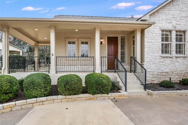 view of exterior entry with covered porch