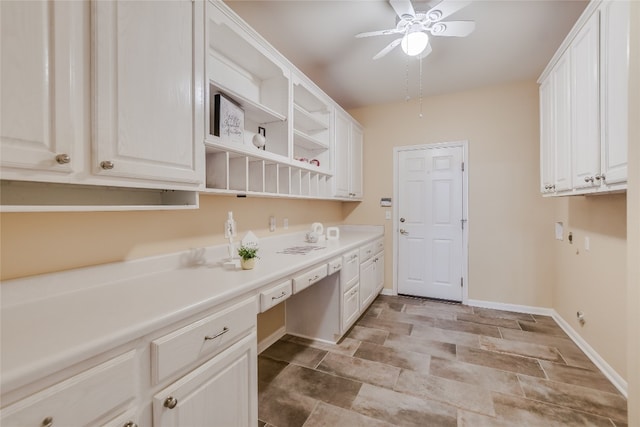 kitchen with ceiling fan and white cabinets