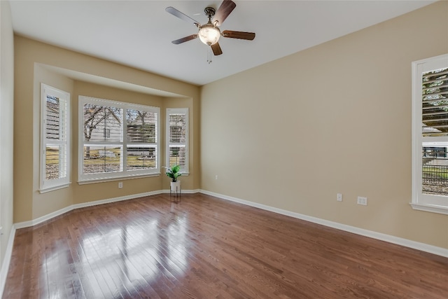 empty room with hardwood / wood-style flooring and ceiling fan