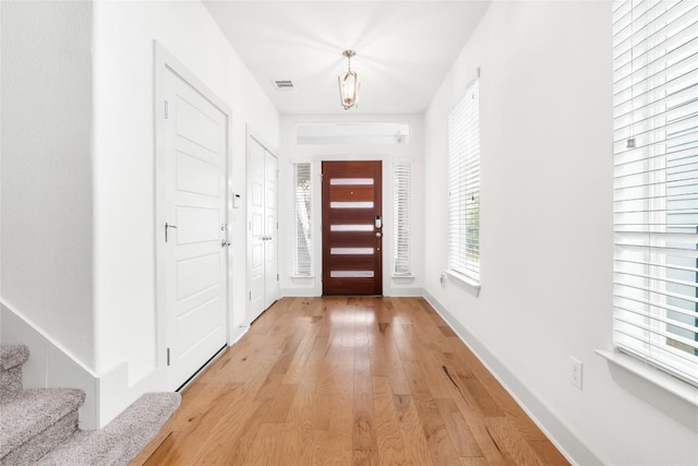 2211 Capulet St, Austin, TX 78741 - foyer entrance with light wood-style flooring, healthy amount of natural light, stairs, and baseboards