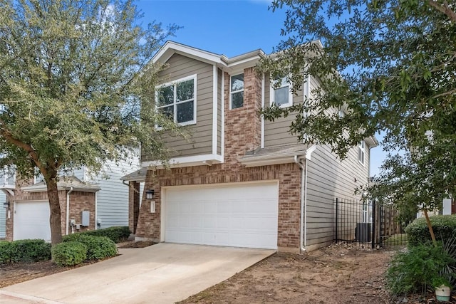 view of front of property with a garage and central AC unit