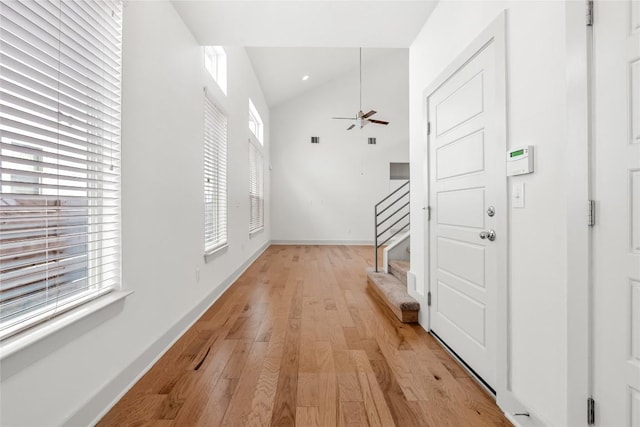 2211 Capulet St, Austin, TX 78741 - corridor with vaulted ceiling, light wood finished floors, stairway, and baseboards