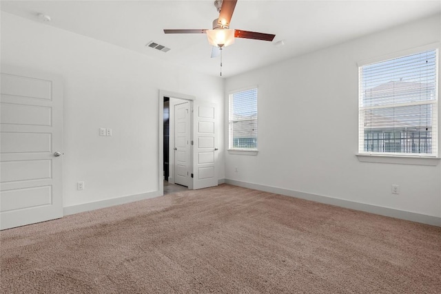 2211 Capulet St, Austin, TX 78741 - unfurnished bedroom featuring light carpet, baseboards, and ceiling fan