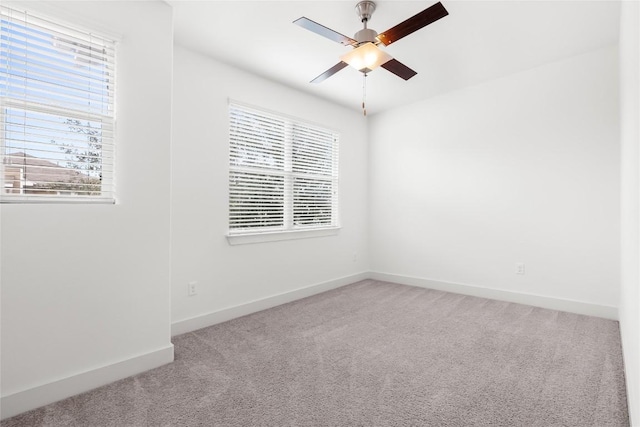 2211 Capulet St, Austin, TX 78741 - carpeted spare room featuring plenty of natural light, ceiling fan, and baseboards