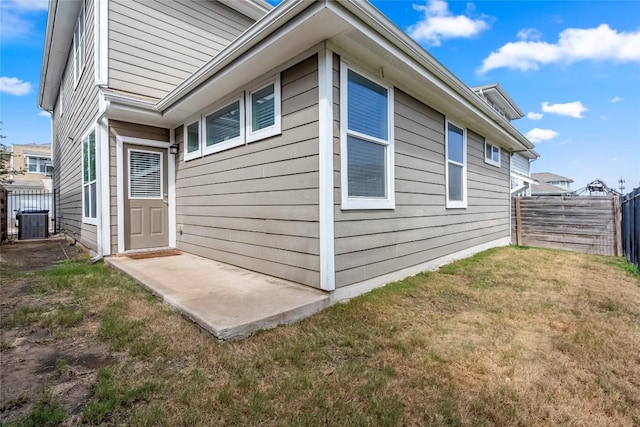 2211 Capulet St, Austin, TX 78741 - view of side of home featuring central AC and a patio