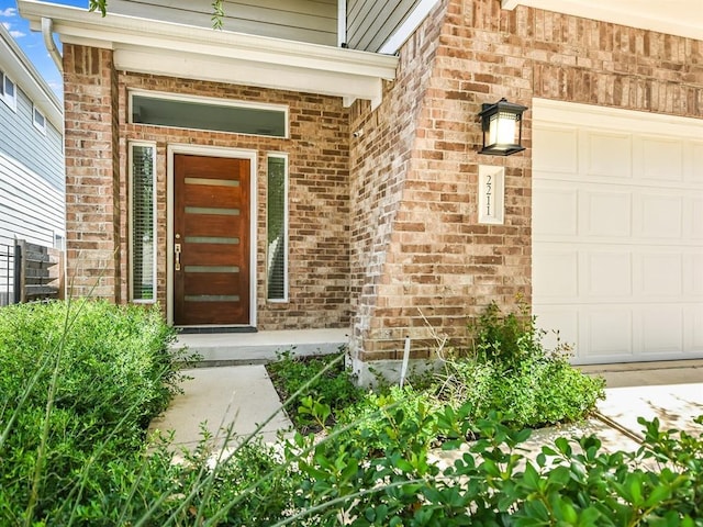 2211 Capulet St, Austin, TX 78741 - doorway to property with brick siding and an attached garage