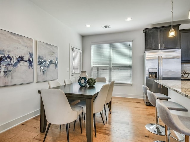 2211 Capulet St, Austin, TX 78741 - dining area featuring baseboards, light wood finished floors, and recessed lighting