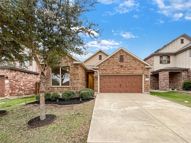 view of front of home with a garage, brick siding, and driveway