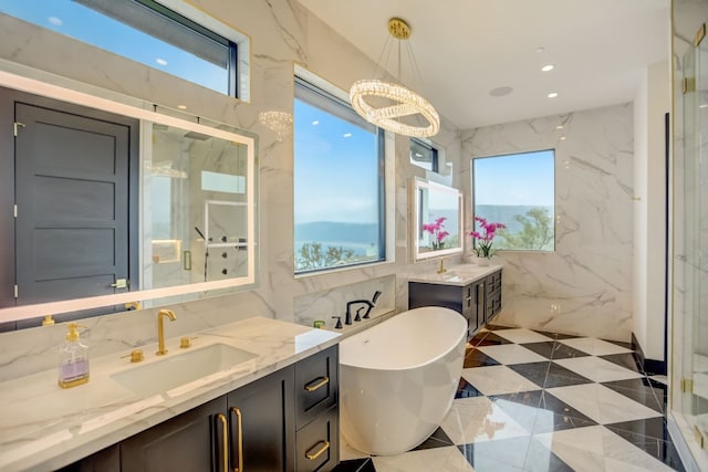 12885 Park Dr, Austin, TX 78732 - full bathroom with vanity, a freestanding bath, a chandelier, a marble finish shower, and recessed lighting