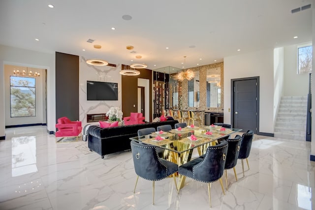 12885 Park Dr, Austin, TX 78732 - dining area featuring stairway, recessed lighting, light marble finish flooring, and a chandelier