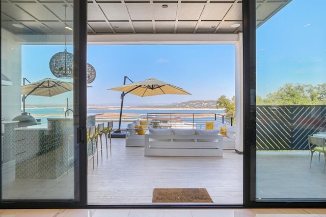 12885 Park Dr, Austin, TX 78732 - doorway with a water view, healthy amount of natural light, and wood finished floors