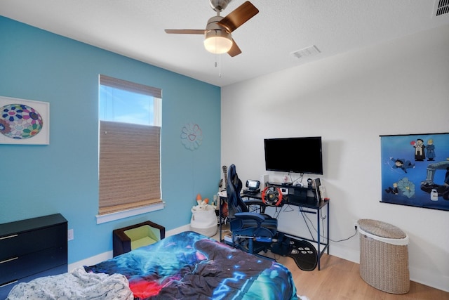 bedroom with hardwood / wood-style flooring and ceiling fan