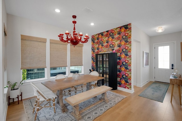 dining room featuring a notable chandelier and light wood-type flooring