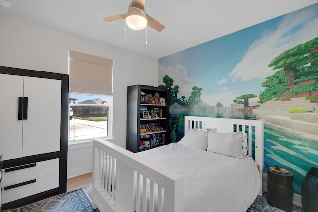 bedroom featuring dark hardwood / wood-style floors and ceiling fan