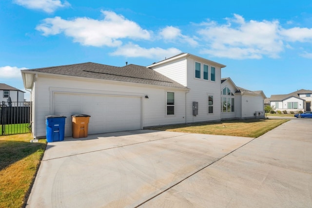 view of front of home featuring a garage and a front lawn