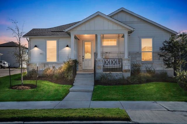 view of front of home with a yard and covered porch