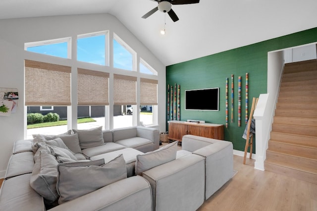 living room with ceiling fan, high vaulted ceiling, light hardwood / wood-style flooring, and a wealth of natural light