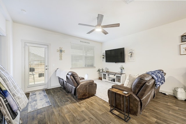 living room with dark hardwood / wood-style floors and ceiling fan