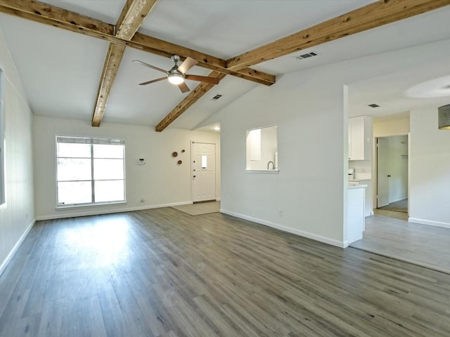 unfurnished living room featuring vaulted ceiling with beams, wood-type flooring, and ceiling fan