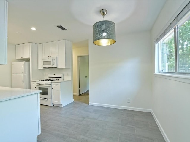 kitchen with white cabinetry, white appliances, and pendant lighting