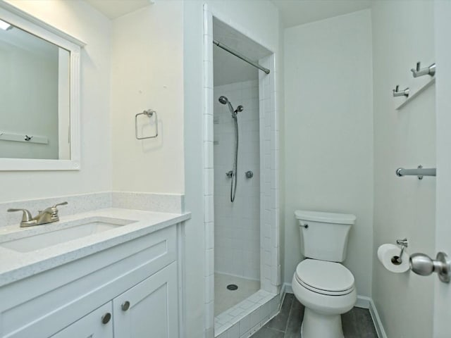 bathroom featuring tiled shower, vanity, and toilet