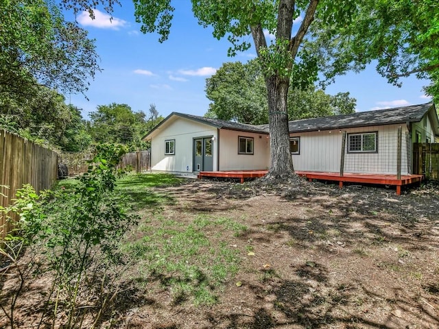 back of property with a wooden deck