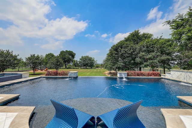 view of swimming pool with pool water feature and an in ground hot tub