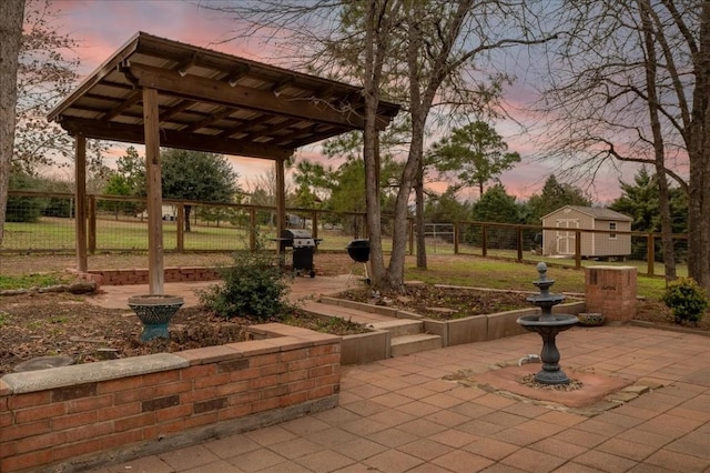 surrounding community featuring a pergola, a shed, and a patio area