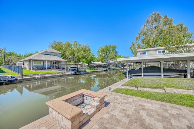 dock area with a water view and a fire pit