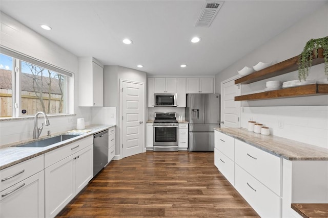 kitchen with white cabinetry, sink, dark hardwood / wood-style floors, and appliances with stainless steel finishes