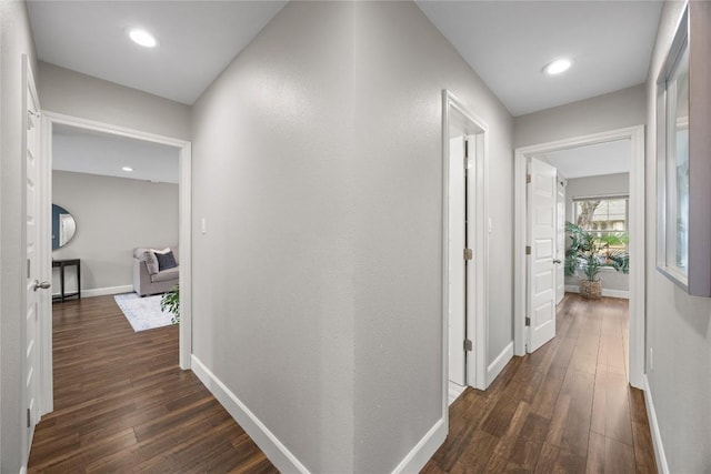 hallway with dark hardwood / wood-style flooring